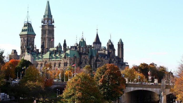 The Canadian flag flies over the Parliament hill in Ottawa, Canada on October 22, 2014. A gun man opened fire at the National War Memorial and killed an soldier and then went into the Parliament Hill in Ottawa and fired several shots in the building. Gunfire echoed through the Gothic halls of the Canadian parliament Wednesday as police shot dead a gunman who had killed a soldier guarding a nearby war memorial before storming the building. Police said an investigation was continuing, but did not confirm earlier reports that more gunmen were involved. Heavily armed officers backed by armored vehicles sealed off the building. There was no immediate word on the gunman's motivation, but the attack came a day after an alleged Islamist drove over and killed another soldier in what authorities branded a terrorist attack. AFP PHOTO / Lars Hagberg (Photo credit should read Lars Hagberg/AFP/Getty Images)